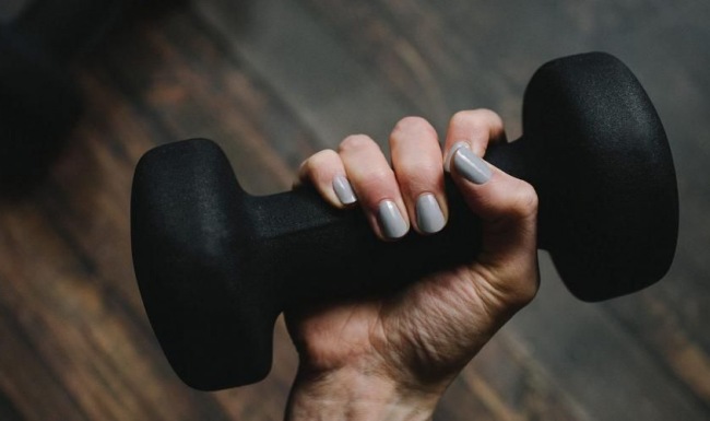 a person's hand holding a dumbbell
