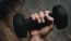 a person's hand holding a dumbbell