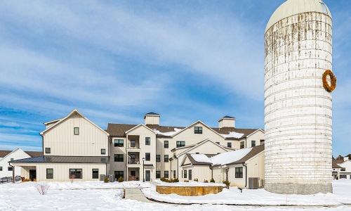 building with silo and snow covered ground